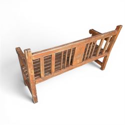 20th century teak cricket bench featuring a central splat with moulded cricket bat and ball motif flanked by stylised wicket spindles, over a slatted seat and square supports