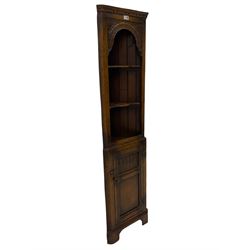 Narrow 20th century distressed oak corner cupboard, fitted with two open shelves above single cupboard