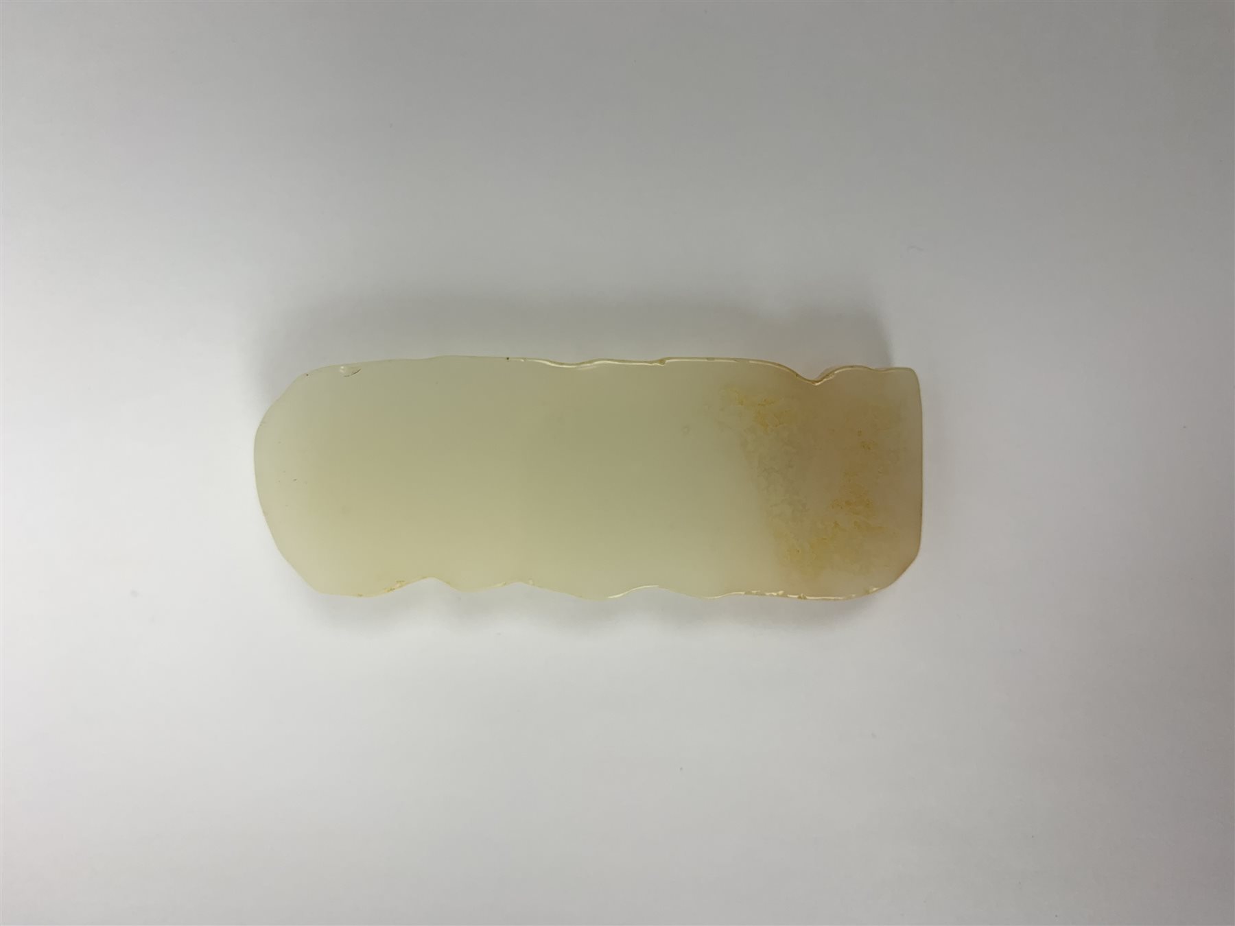 A white Hetian and russet carved jade buddha, H9.5cm.