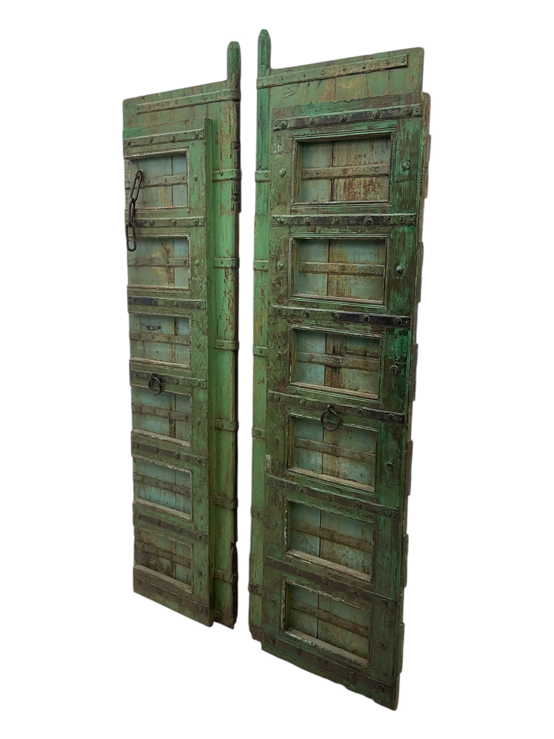 Pair of green-painted Indian doors, c.1860–1880, made from solid teak featuring original iron work and hand-painted finish