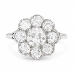Early 20th century platinum diamond daisy flower head cluster ring, principal round cut di...