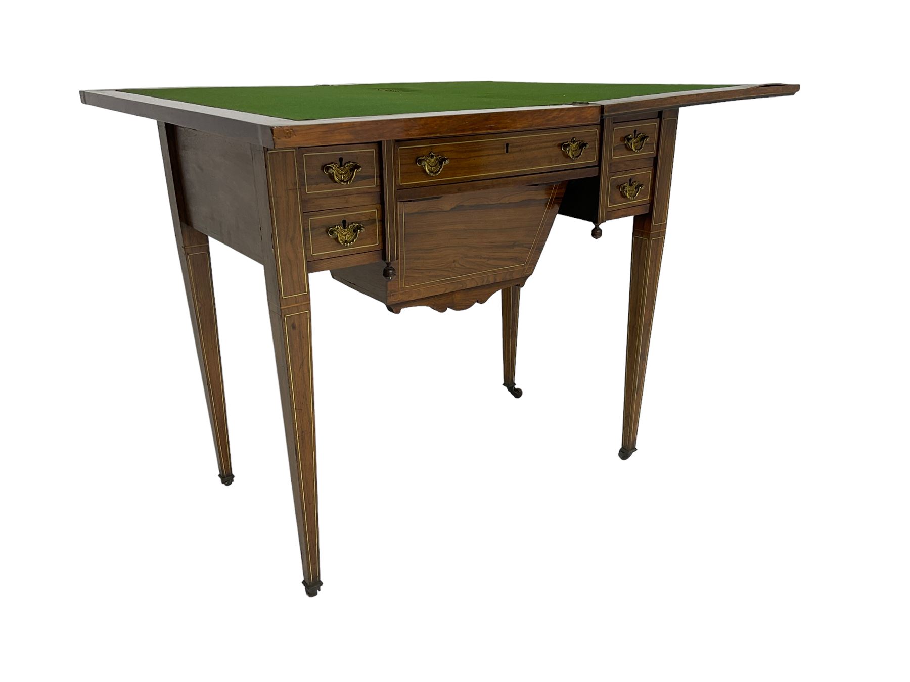 Edwardian inlaid mahogany games or work table, rectangular fold-over top inlaid with stylised dragon ivorine decoration and stringing, fitted with one long flanked by four small drawers over sewing compartment drawer, raised on square tapering supports with castors