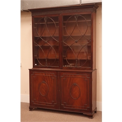  19th century mahogany Hepplewhite style bookcase on cupboard, projecting dentil cornice above blind fret work frieze, two glazed doors with eight adjustable shelves, two cupboard doors, bracket feet, W161cm, H242cm, D46cm  