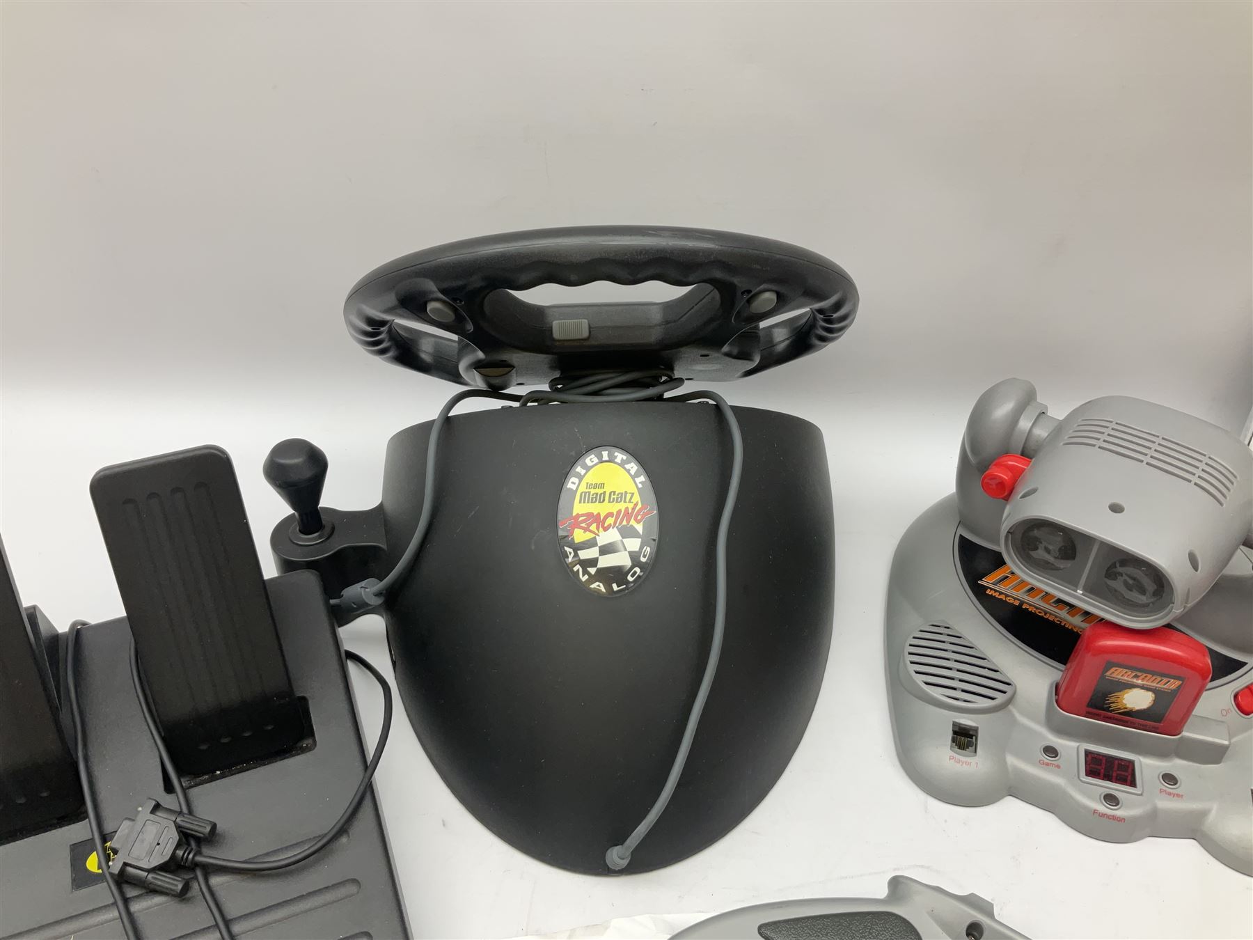 Mad Catz Dual Force Racing Wheel and Foot control for Playstation; Arcadia Image Projecting Game System; pair of Captain Scarlet and the Misterons phaser guns etc