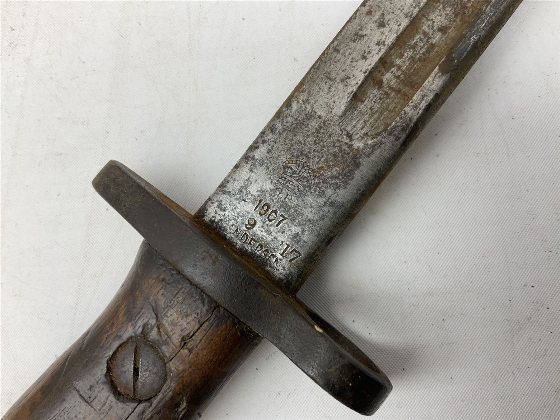 British Pattern 1907 bayonet with 43.5cm fullered steel blade; in leather scabbard with webbing frog L58cm overall; another Pattern 1907 bayonet lacking scabbard; and British Pattern 1888 Mk.I bayonet by Wilkinson London (no scabbard) (3)