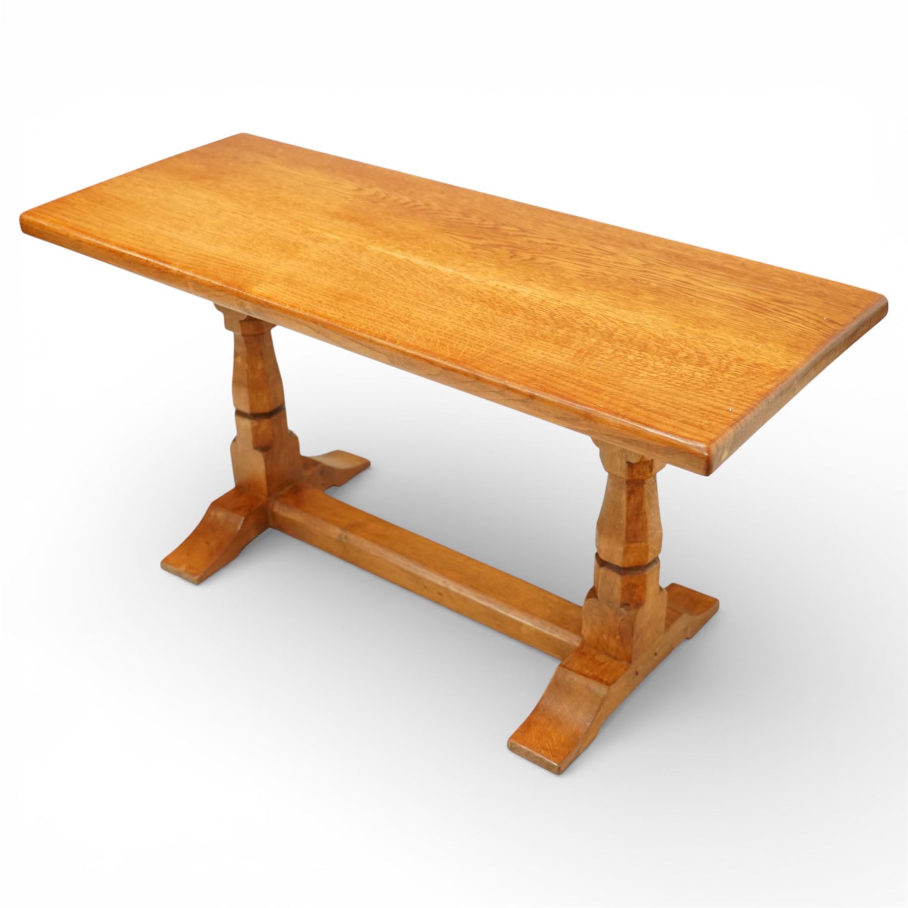 Sid Pollard of Thirsk - Yorkshire oak coffee table, rectangular adzed top with softly moulded edge, raised on twin octagonal baluster supports, united by a plain stretcher, on shaped splayed feet