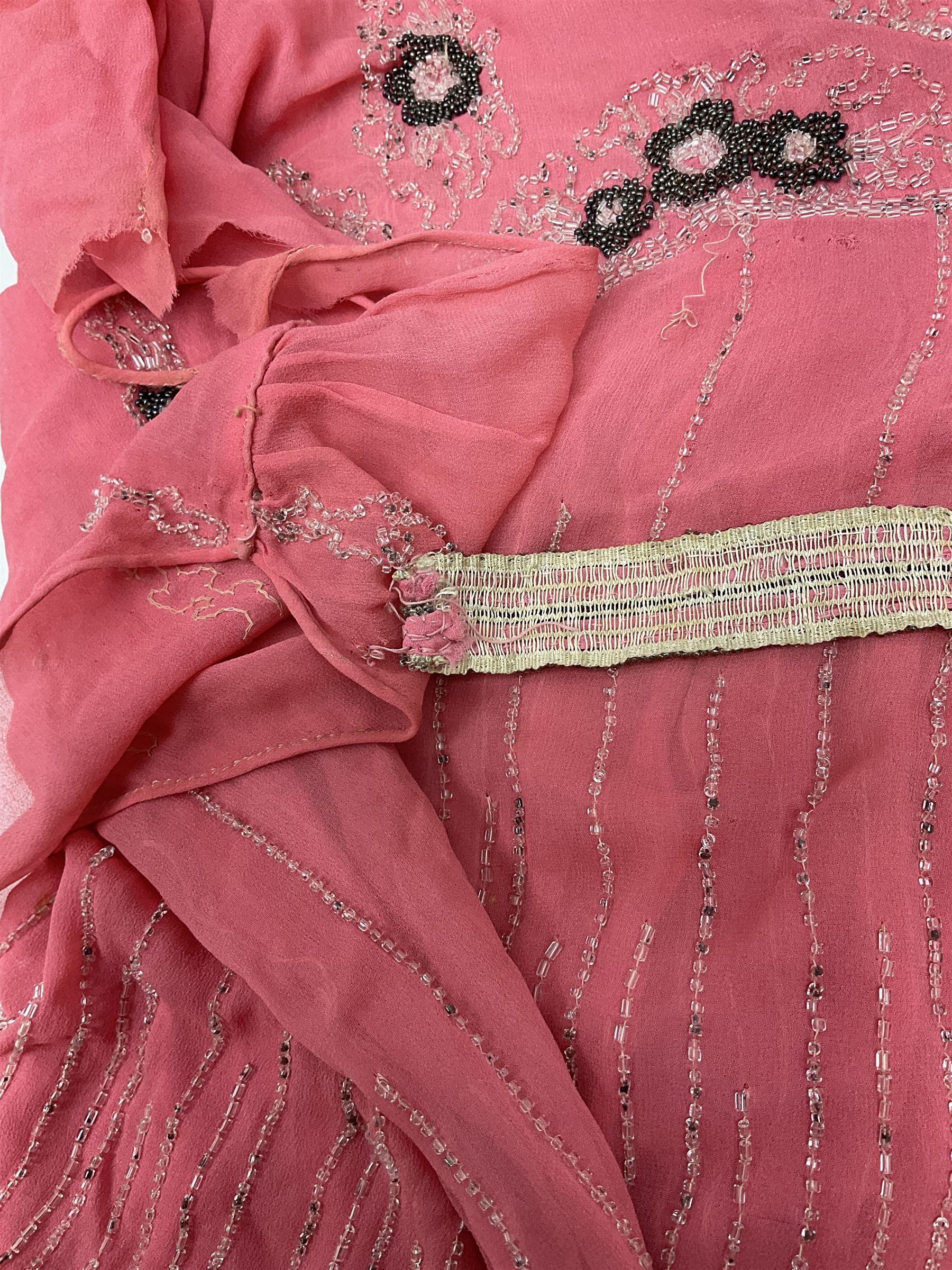 Art Deco pink flapper type beaded dress, with floral motifs and tasselled clear and black beadwork throughout