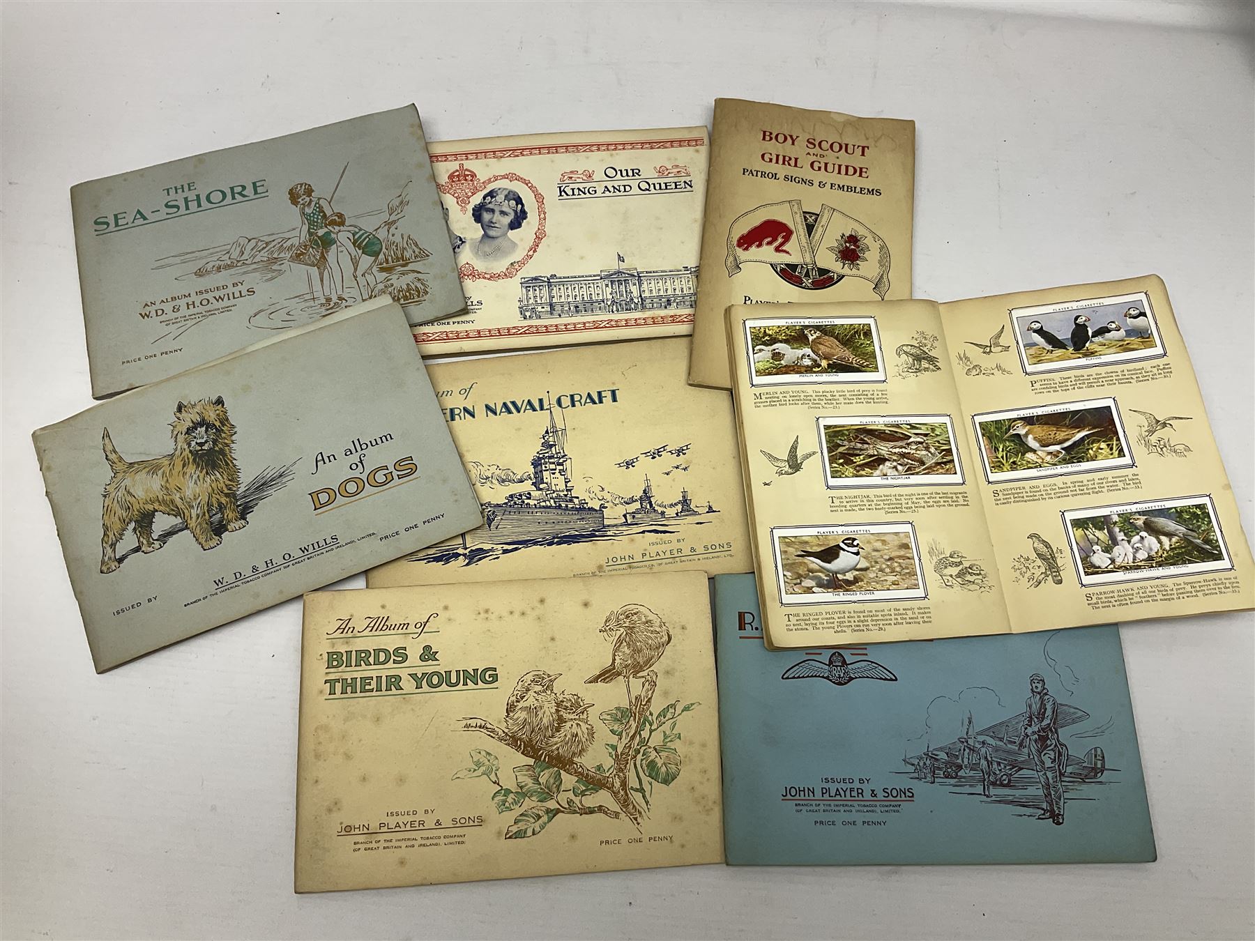 Early 20th century ephemera, to include signed photographs of Charles Boyer and Walter Pidgeon etc, a printed letter from Winston Churchill, two albums and a quantity of transfer books of Players and similar cigarette cards, including Boy Scout and Girl Guide Patrol Signs and Emblems and RAF Badges, a collection of greetings cards and postcards, a photograph album containing black and white photographs of Caius College Cambridge and guides and pamphlets on travelling Switzerland and the UK