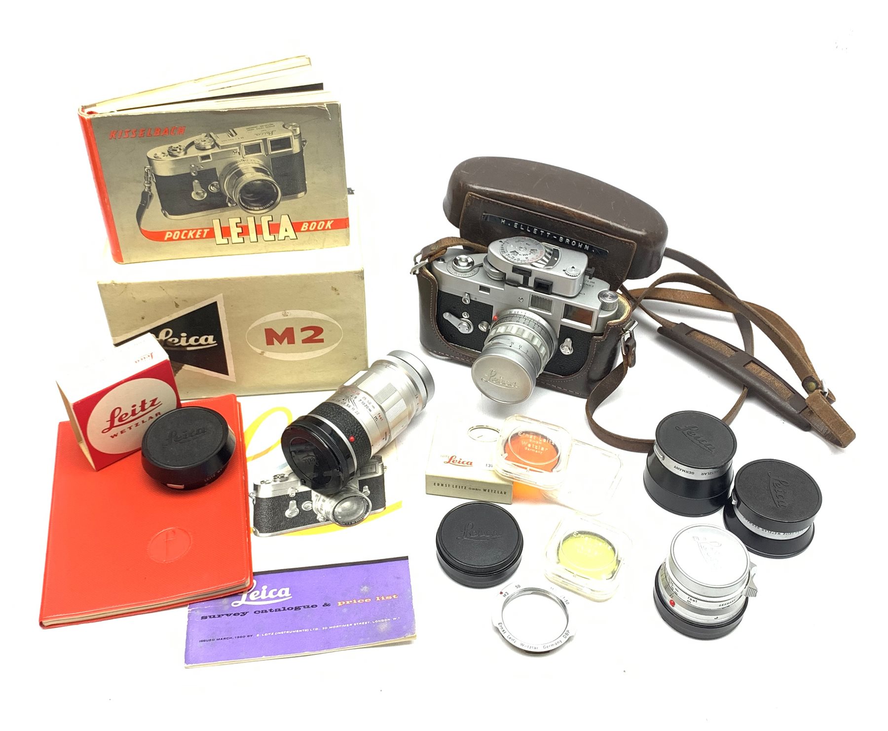 Leica M2-1013180 camera fitted with Leica Summicron 1:2/50 Leitz Wetzlar lens (1764800) and UVa filter, and Leica-Meter MR in leather case together with; Leica Elmarit 1:2.8/90 LW lens (1805634), Leica Summaron 1:28/35 LW lens (1782507), Leica M3 M2 adapter ring, Leica filters yellow and orange cased, three Leica lens hoods IUFOO, IROOA and 12585H (boxed), Leica pocket book, guide and 1960s survey catalogue & price guide leaflet, with original M2 camera box
