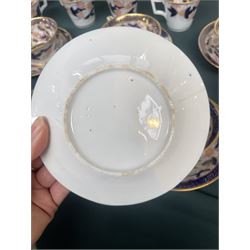 English porcelain Imari tea and coffee wares, pattern 1277, decorated with central orange floral motif surrounded by sprigs of yellow foliage within blue borders, comprising eleven teacups, eight coffee cups, twelve saucers, two shallow bowls and one finger bowl