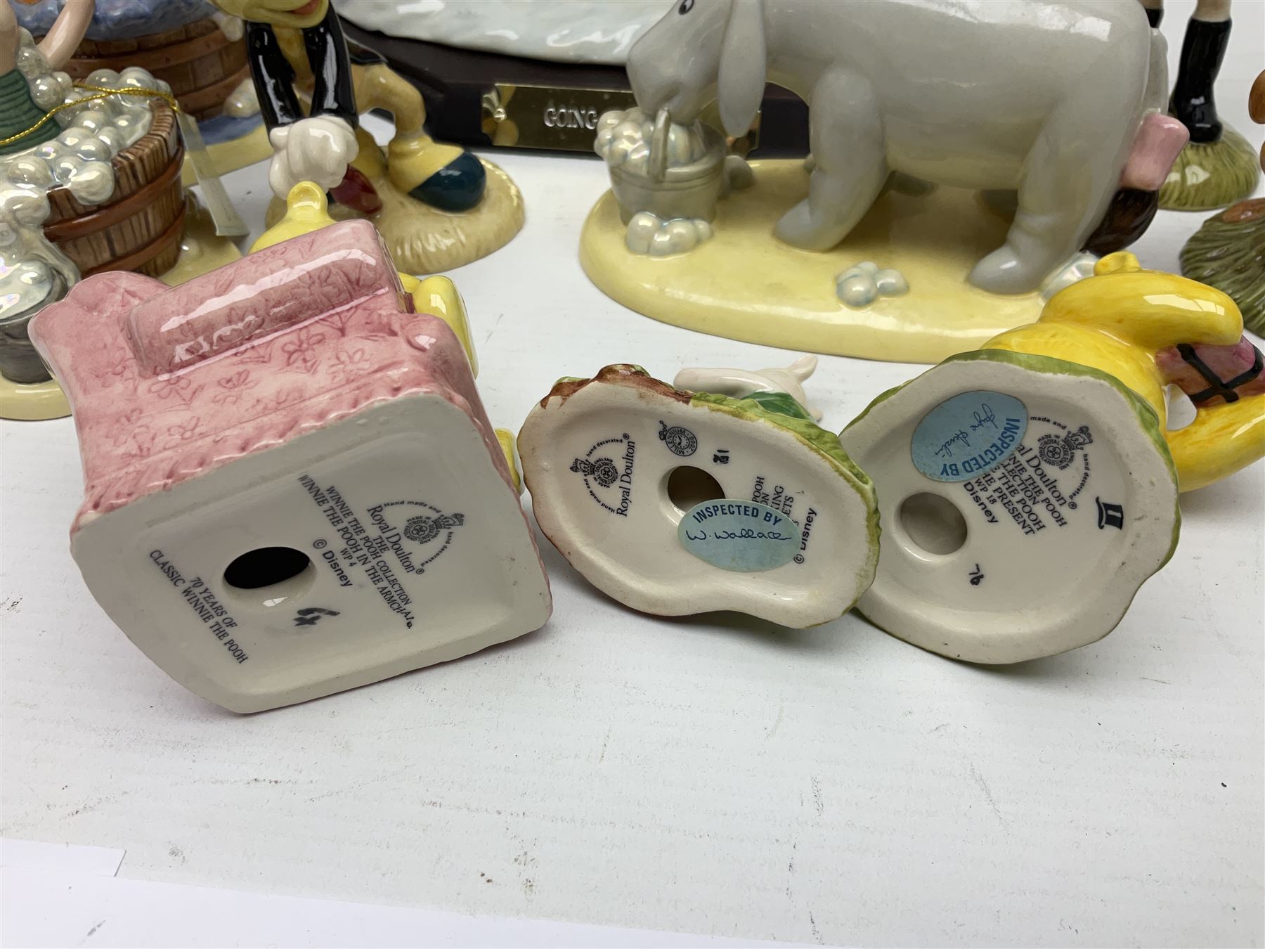 Nine Royal Doulton Winnie the Pooh Collection figures, including Oh Dear Bath Time's Here, Going Sledging, Tigger's Splash Time and Christopher Robin, together with a Royal Doulton Disney Showcase Jiminy Cricket figure, all boxed