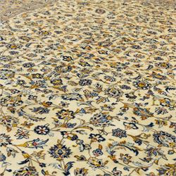 Central Persian Ardakan hand-knotted carpet, ivory field finely decorated with a symmetrical lattice of scrolling vines palmettes and flowering sprays arranged around a delicate central medallion enclosed by a pale border of stylized floral and vine ornament between multiple guard stripes with cotton fringe ends 