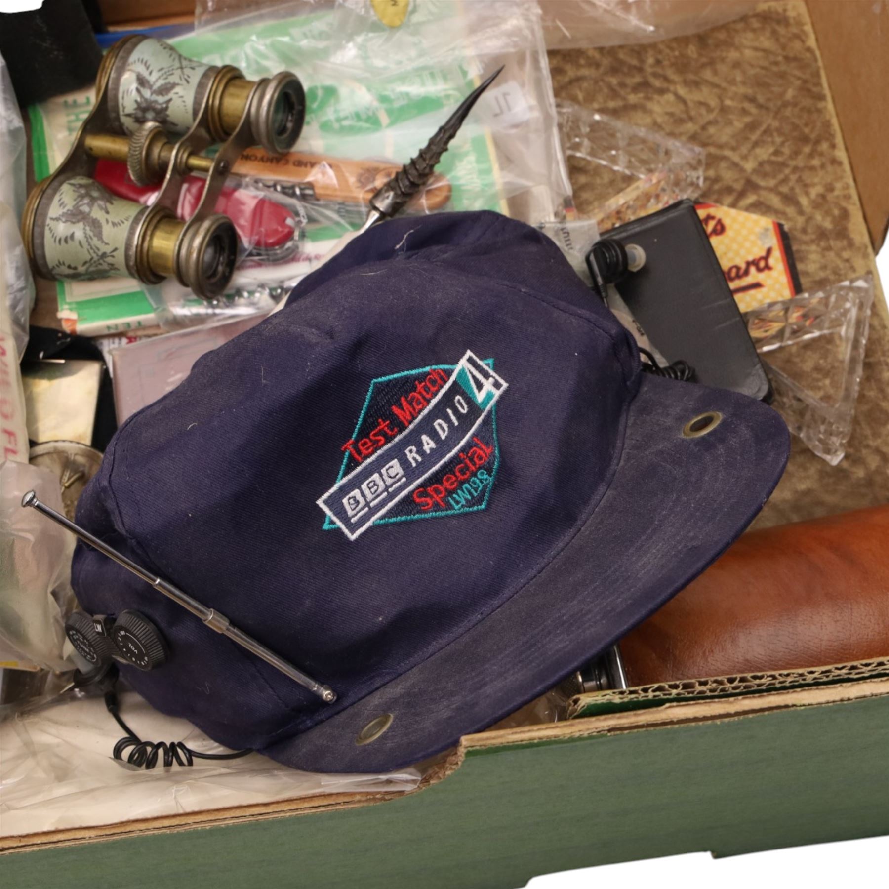 Tony Lama buckle, Austin spare parts catalogue, Swiss army knife, BBC Radio Test Match cap, horn handled letter opener etc