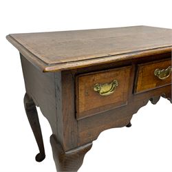 George III oak lowboy, rectangular top with walnut banding and moulded edge, fitted with three drawers with pressed brass handle plates and pulls, the shaped apron over cabriole supports with pad feet