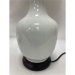 Pair of Chinese ivory crackle glazed table lamps, each of bottle form, raised upon circular hardwood base, excluding fittings H43cm