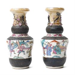 Pair of Chinese Nanking famille rose vases, painted with warriors parading, the neck mould...