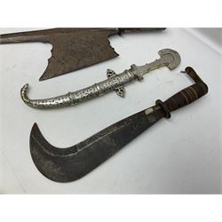 Moroccan jambiya dagger with 24.5cm plain curved blade stamped LONDON to the ricasso area, the hilt and scabbard overlaid with plain sheet brass to the back and ornate silver coloured metal to the front; waisted grip and arched pommel; two pyramid mounts to the scabbard L41cm overall; large billhook with curving blade and stacked leather washer grip; and a reproduction halberd blade (3)