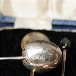 Set of six silver coffee spoons with shaped terminals, cased London 1924, another set of similar spoons London 1924 cased and a set of six silver bead knop spoons Birmingham 1936, cased