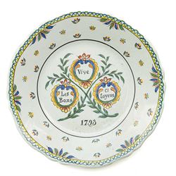 Set of four French Nevers style revolutionary faience plates, the first painted with a portrait of 'Evêque de Meaux' or the Bishop of Meaux,  another decorated with a putto holding a flaming torch and a flag inscribed 'W Lamour' beneath a slogan 'Cest le moment de faire un petit enfant' or 'Now is the time to make a child', another decorated with 'Vive les bons citoyens' or 'Long live the good citizens' within foliage, and another with a portrait of an officer, probably Napoleon, with the phrase 'Vive la Nation' or 'Long live the Nation', each bearing dates, with indistinct blue monogram to bases, D24cm (4)