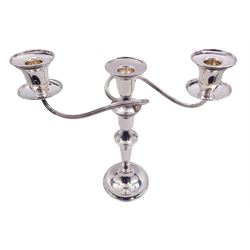 Modern silver twin branch candelabra, the filled circular base with personal engraving leading to a tapering stem supporting a central plain socket with removable nozzle, and two scrolling branches with conforming sockets and nozzles, hallmarked Parkin Silversmiths Ltd, Sheffield 1987, H27cm