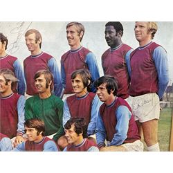 1970-1 photograph of West Ham United FC squad members, including Bobby Moore, Geoff Hurst, Harry Redknapp, Trevor Brooking, Jimmy Greaves, Billy Bonds etc, most players with signatures, 30 x 45cm, framed and glazed