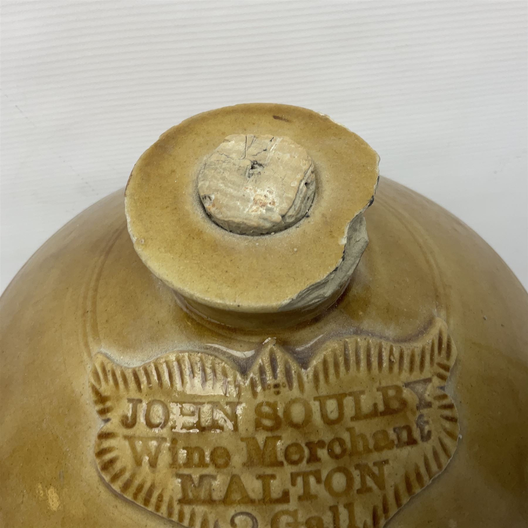 Large 2 gallon stoneware flagon, stamped 'John Soulby Wine Merchant Malton 2 Gall', together with a collection of similar stoneware jars and bottles, largest H40.5cm
