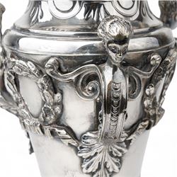 19th century silver plated vase of tapering form with lappet border and three caryatid handles surrounded with laurel wreath cartouches raised on triple paw feet on lobed base H28cm