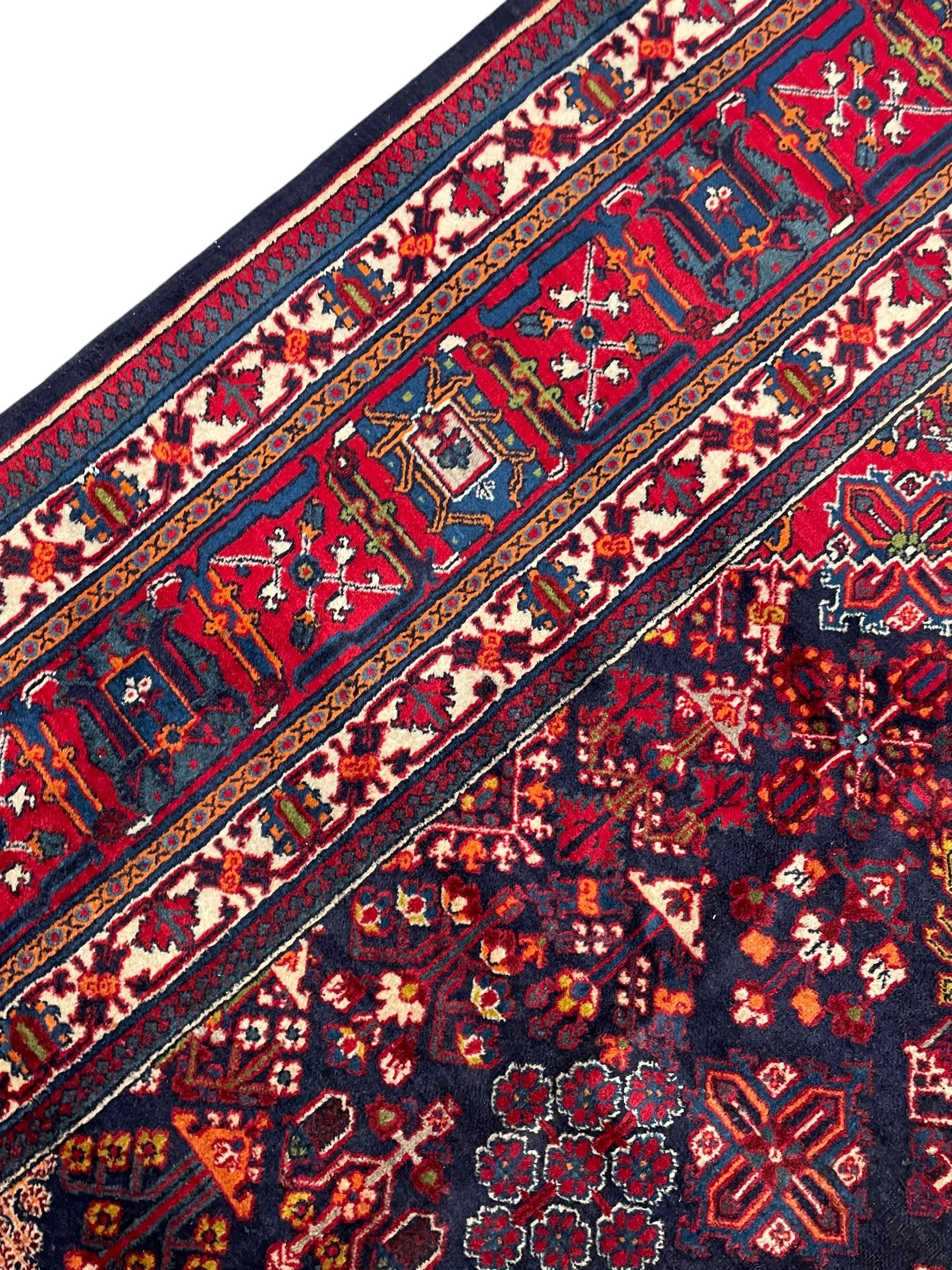 Persian Meimeh indigo ground rug, the central medallion within a field of small floral lozenge motifs, the guarded border with repeating pattern