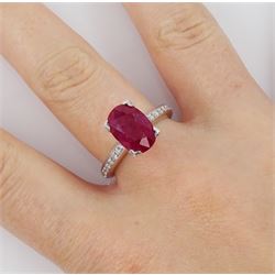18ct white gold ruby and diamond ring, single oval cut ruby of approx 2.75 carat, with channel set diamond shoulders, hallmarked
