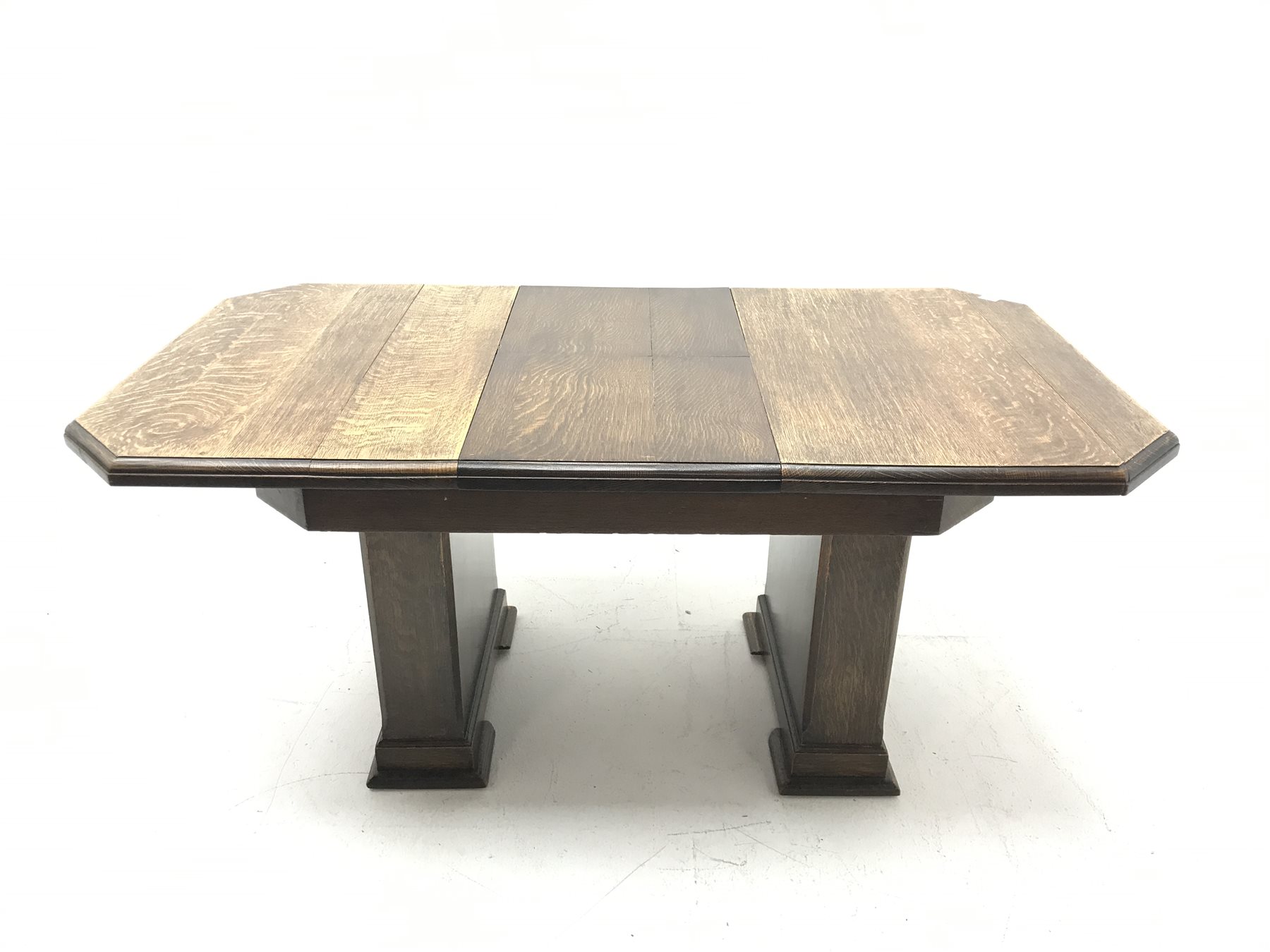 'The Celerity Patent' - Early 20th century oak extending dining table, canted rectangular moulded top with foldout leaf, on two rectangular box supports, 91cm x 122cm - 167cm, H74cm