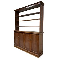 20th century mahogany bookcase on cupboard, projecting cornice over three shelves, the lower section enclosed by two double panelled cupboards, on skirted base