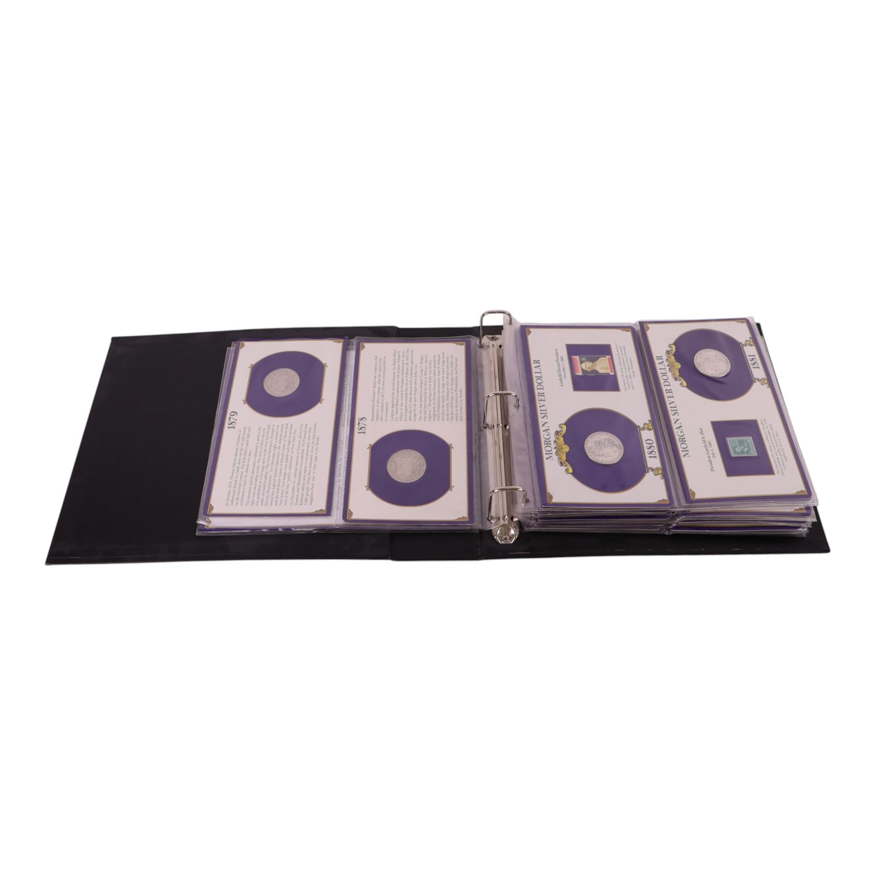 Twenty-five United States of America silver one dollar coins, comprising eighteen 'Morgan' and seven 'Peace' dollars, in 'The U.S. Silver Dollar Collection' ring binder