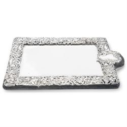 Edwardian silver mounted dressing table mirror, the bevelled mirror plate with silver surround embossed with flowers, C scrolls, putti and birds, with velvet easel support verso, hallmarked London 1903, maker's mark WC, probably for William Comyns & Sons, H33cm