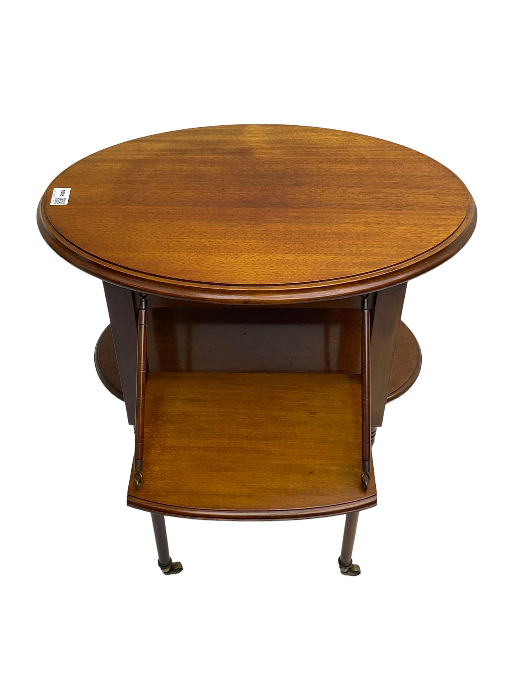 An unusual Edwardian mahogany drop leaf centre table, oval form with two drop leaves on sliding
