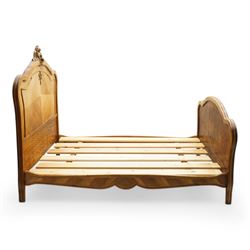 Mid-20th century French walnut small double 4' 2'' bedstead, shaped and moulded headboard with shell and curl acanthus leaf carved pediment with extending flower heads, quarter-matched veneers decorated with applied mouldings and cast gilt metal ribbon tie 