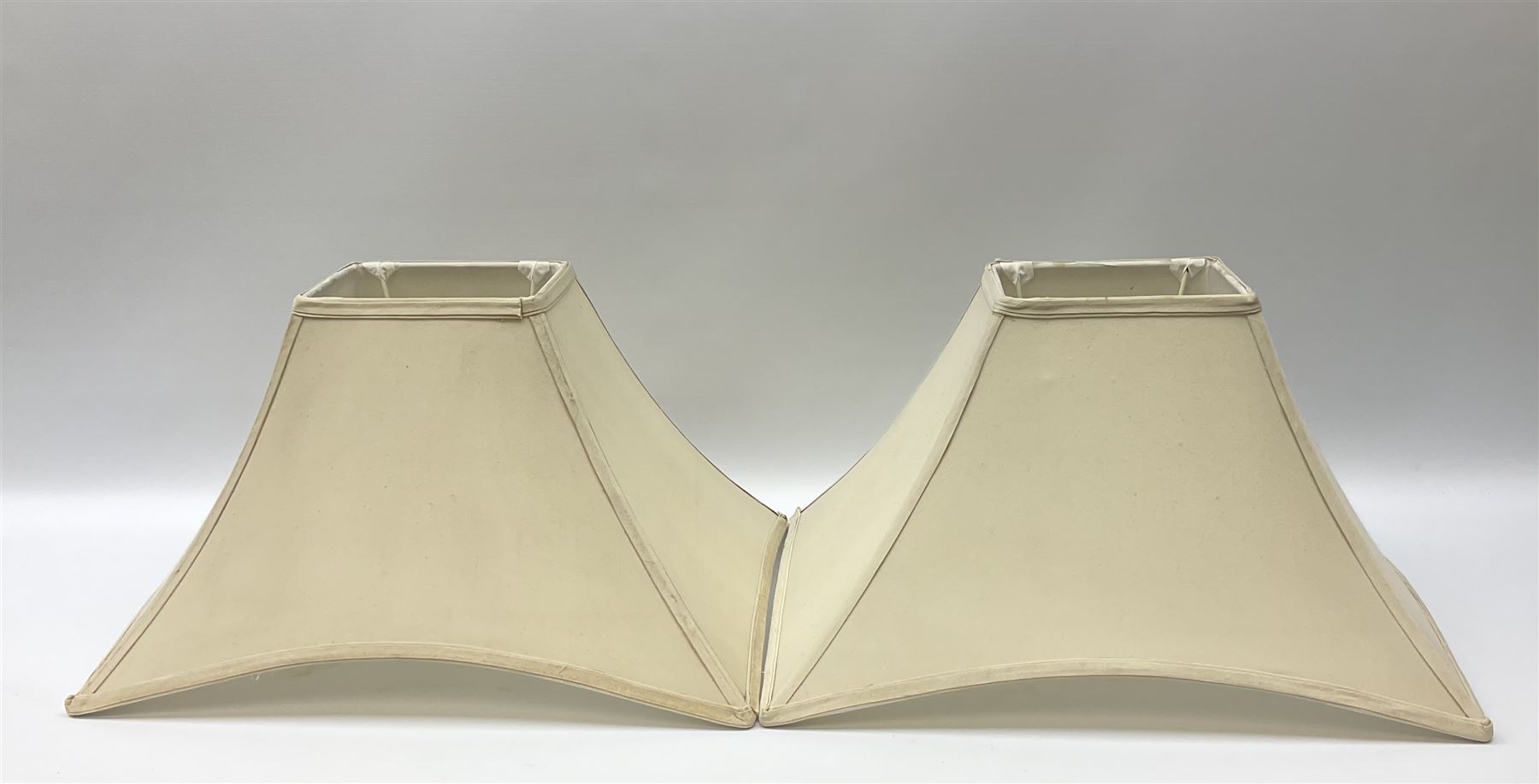 Pair Oriental table lamps decorated with birds in a tree with fruit, on a red ground with a gilded base together with cream lampshades H57cm, without lampshade. 