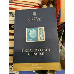 Stamp and coin reference materials, including Stanley Gibbons 2023 'Great Britain Concise' stamp catalogue, various editions of 'The Postal Stationary Society', empty stamp albums etc, in two boxes