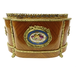 Late 19th/ early 20th century French kingwood two handled jardiniere of elongated quatrefoil form with foliate gilt metal mounts, porcelain panel painted with floral sprays in the Sevres style below a pierced gallery on four scroll feet with removable tin liner, L36cm x H19cm x D23cm. Provenance Property of Bob Heath, Brandesburton Formerly of Ravenfield Hall Farm near Rotherham  