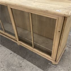 19th century pine cabinet, raised shaped back over rectangular top, enclosed by two sliding glazed doors, on turned feet - THIS LOT IS TO BE COLLECTED BY APPOINTMENT FROM THE OLD BUFFER DEPOT, MELBOURNE PLACE, SOWERBY, THIRSK, YO7 1QY