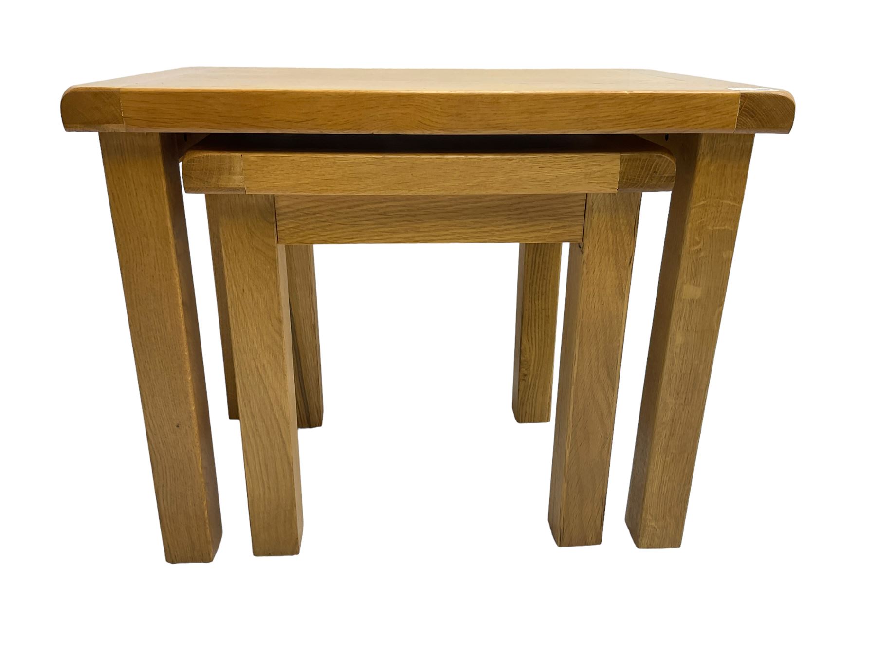 Light oak nest of two tables, rectangular top raised on square supports
