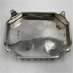 Victorian silver four piece tea service, comprising teapot, teapot stand, twin handled open sucrier and milk jug, each of octagonal form with foliate bud border and engraved decoration including crest to canted panels, and vacant panels, the teapot with ivory finial to the hinged cover and later wooden handle, hallmarked Edward Barnard & Sons Ltd, London1896, teapot including finial H15cm, milk jug including handle H16cm, teapot stand W11.5cm

This item has been registered for sale under Section 10 of the APHA Ivory Act