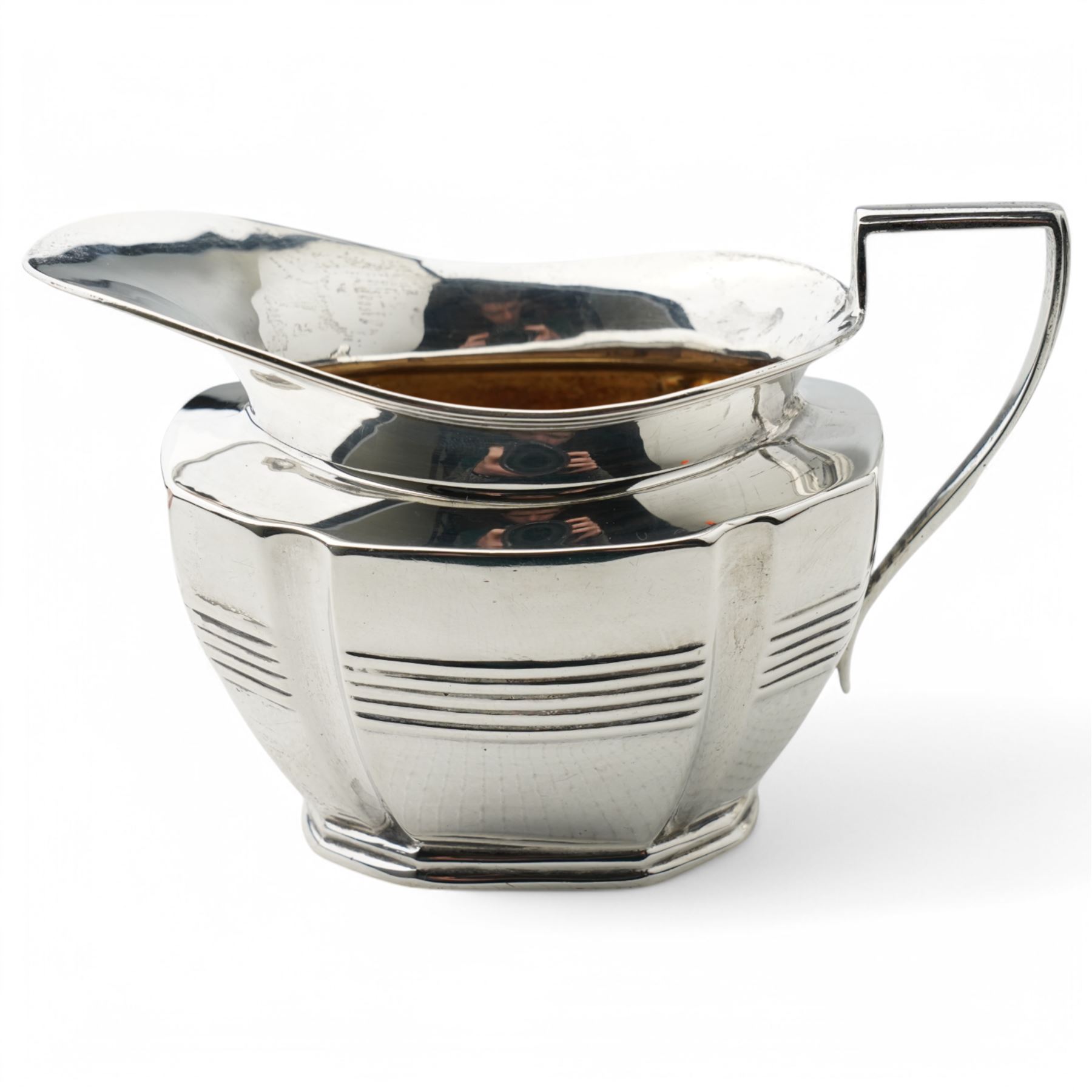 Late Victorian silver three piece tea set of panel sided oval design, the teapot with ebonised handle and lift, Chester 1898/99 Maker Florence Warden and William Aitken