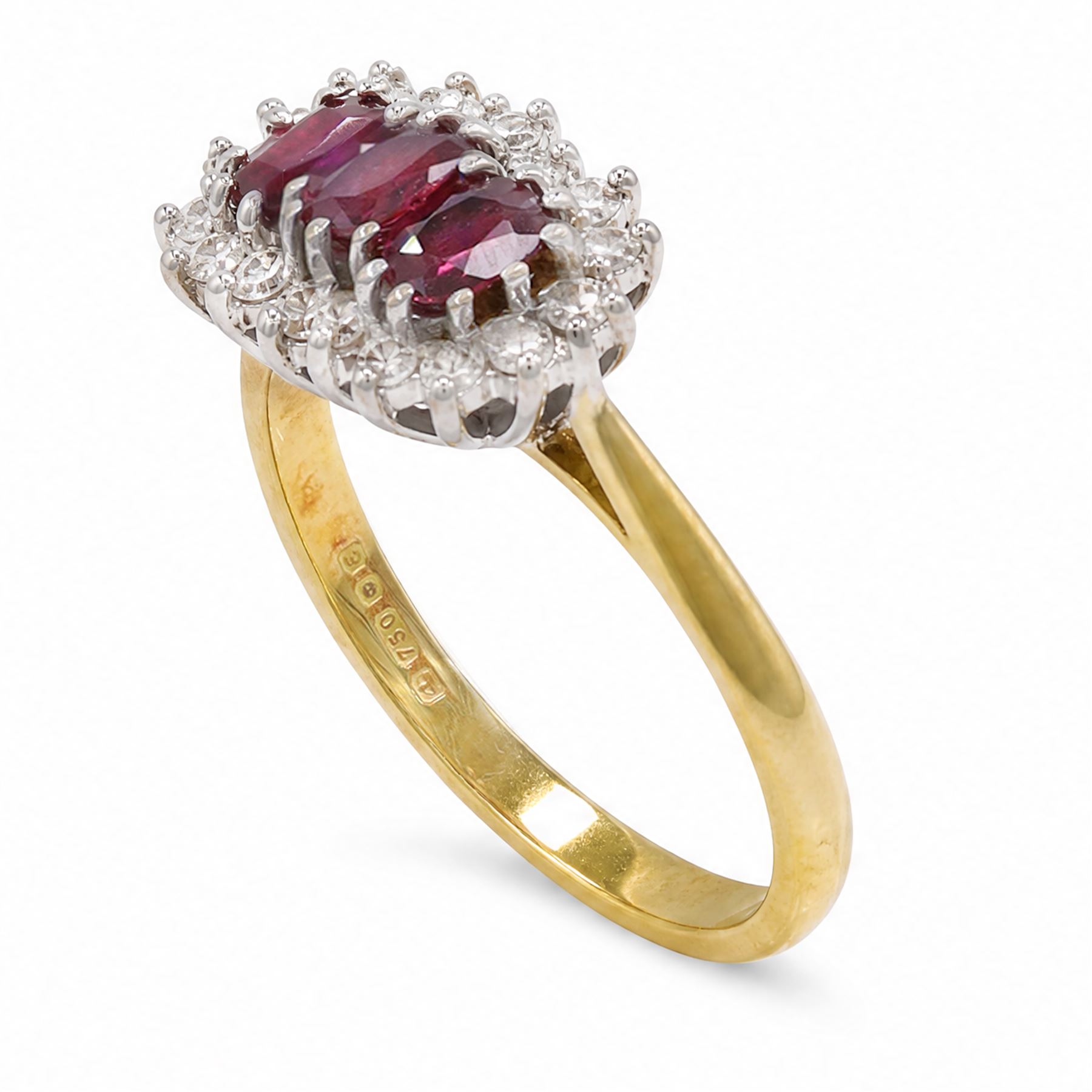 18ct gold ruby and diamond cluster ring, three oval cut rubies surrounded by eighteen single cut diamonds, London 1979, total ruby weight approx 0.55 carat, total diamond weight approx 0.20 carat