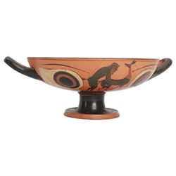 Greek Attic Black-figured eye cup, of typical form with twin handles, the exterior painted with erotic figures flanked by apotropaic eyes, the black interior with reserved tondo with ring dot motif, upon pedestal foot, including handles H9.5cm W28.5cm cup D21.5cm
