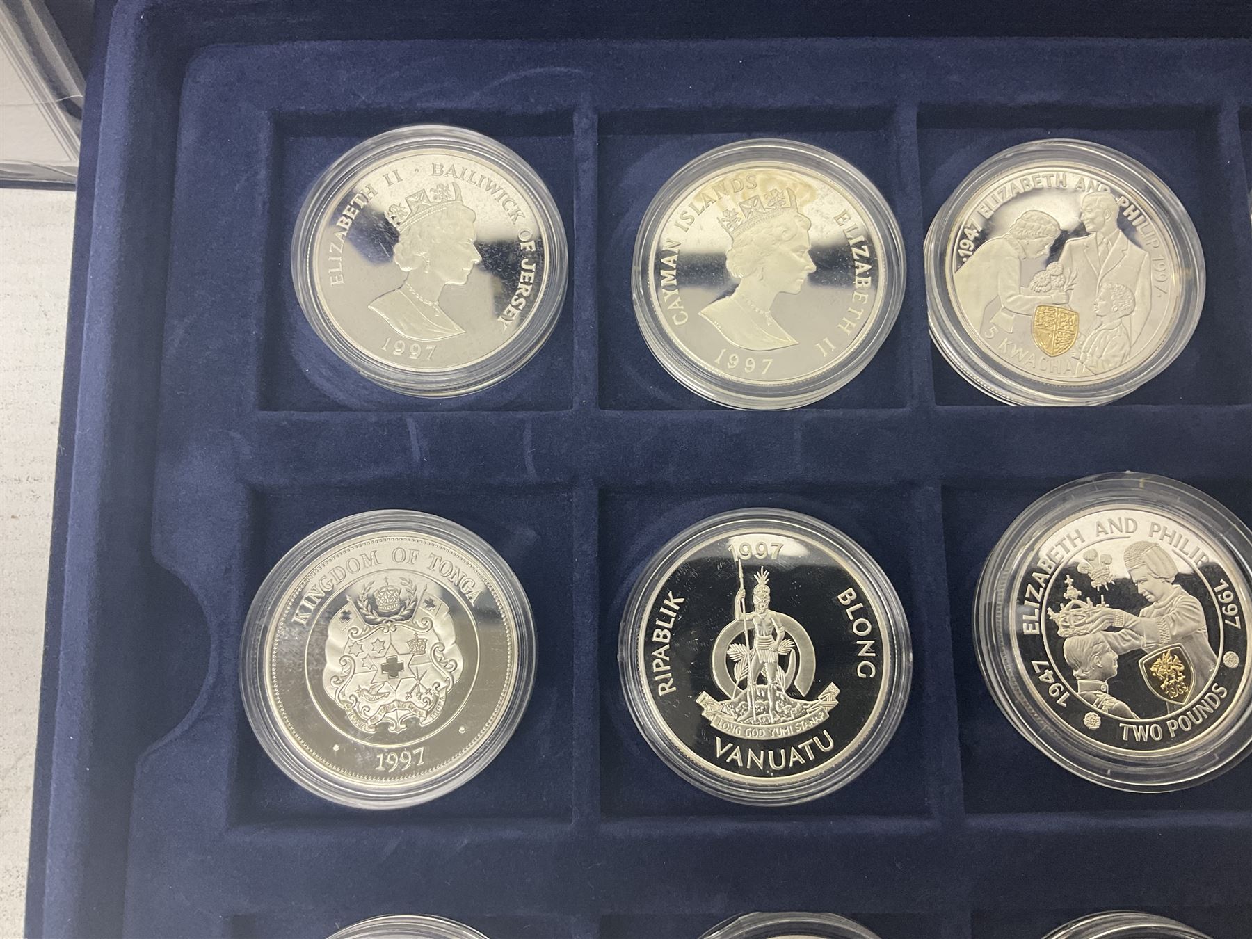 The Royal Mint Golden Wedding Anniversary silver proof coin collection, comprising twenty-four international commemorative coins, cased with certificates