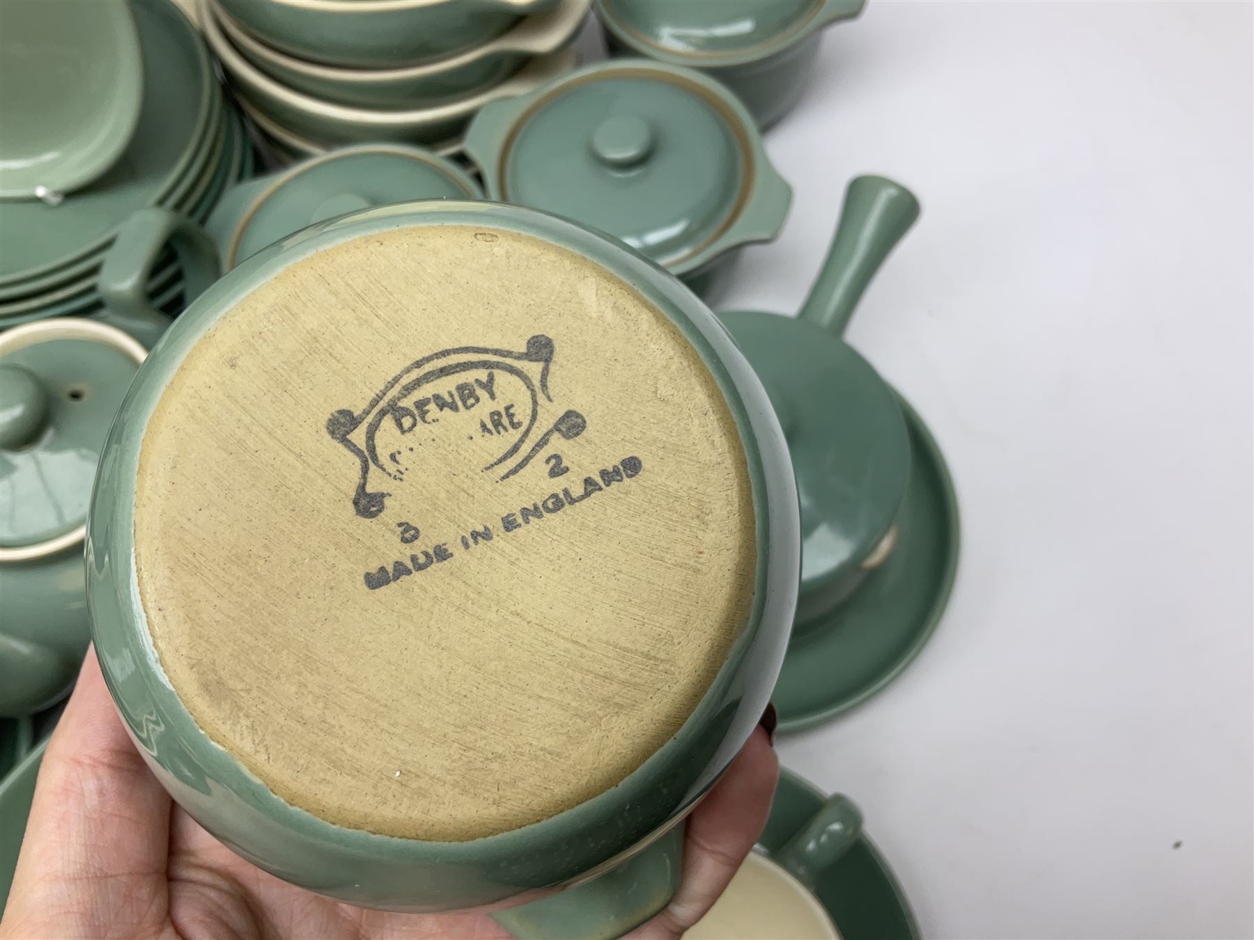Denby Manor Green pattern part tea and dinner service, to include seven dinner plates, thirteen side plates, ten dessert plates, two oval dishes of various sizes, four cups and saucers, seven bowls with covers, two teapots etc (74)  