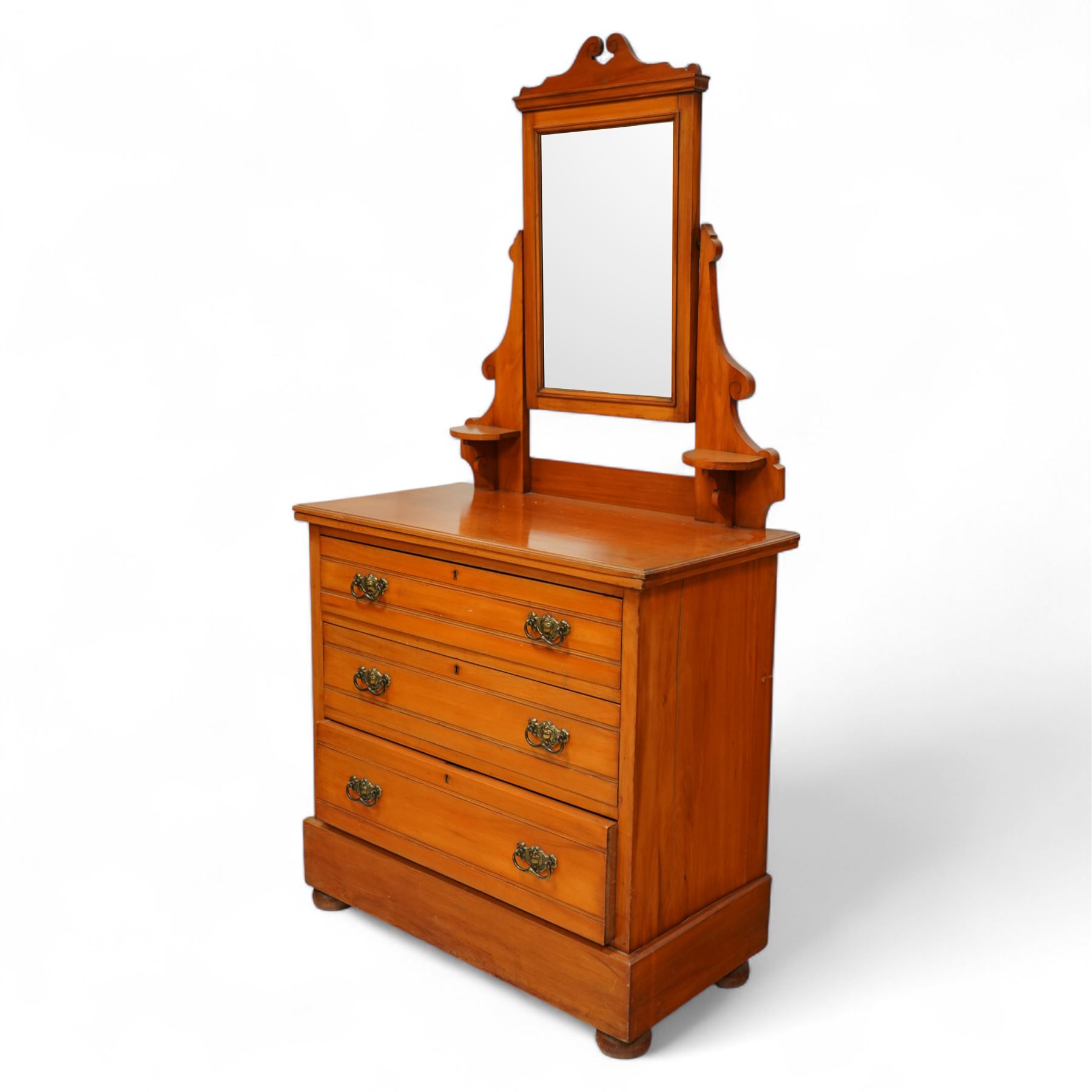 Early 20th century satin walnut wardrobe and dressing table, including a tall single wardrobe with mirrored door beneath a shaped cornice and moulded pediment, (H 205cm, D 39cm, W 91cm) and a matching dressing chest with glazed lift-top compartment and three drawers, mirror supported by scrolled uprights with flanking open shelves (H 170cm, D 45cm, W 84cm)