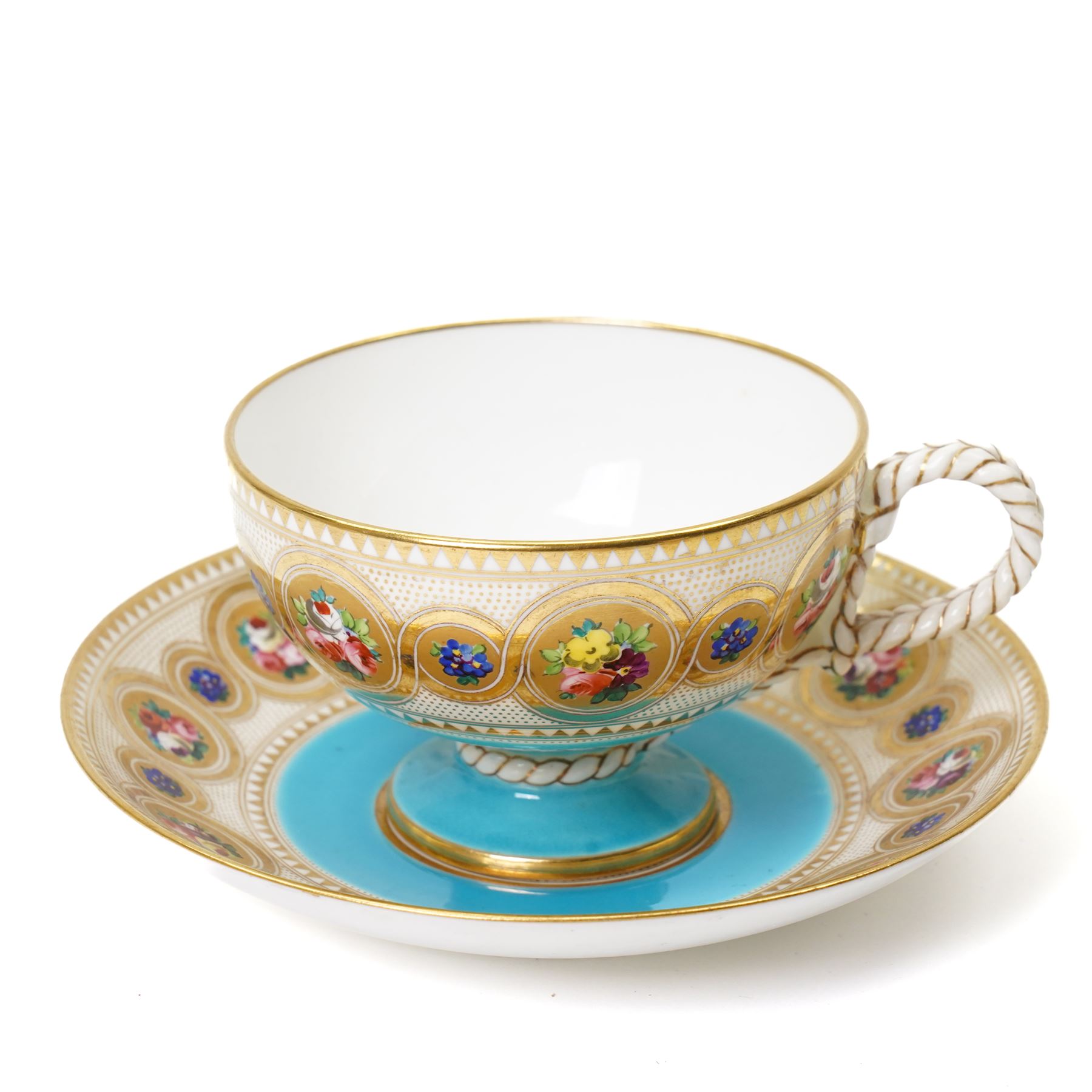 Brown-Westhead, Moore & Co cabinet cup and saucer, with rope twist moulded handle, hand-painted with floral reserves against a white and sky blue ground, heightened profusely with gilt, together with a pink hand-painted example, and a 19th century spill vase and twin-handled covered sucrier (4)