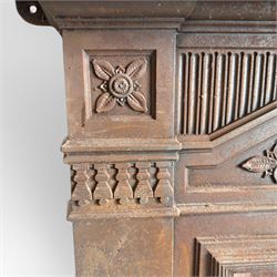 Late Victorian cast ion bedroom fireplace, decorated with floral poppy motifs and flluting