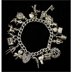 Silver charm bracelet with heart padlock clasp and eighteen silver charms including alarm clock, ballerina and mouse